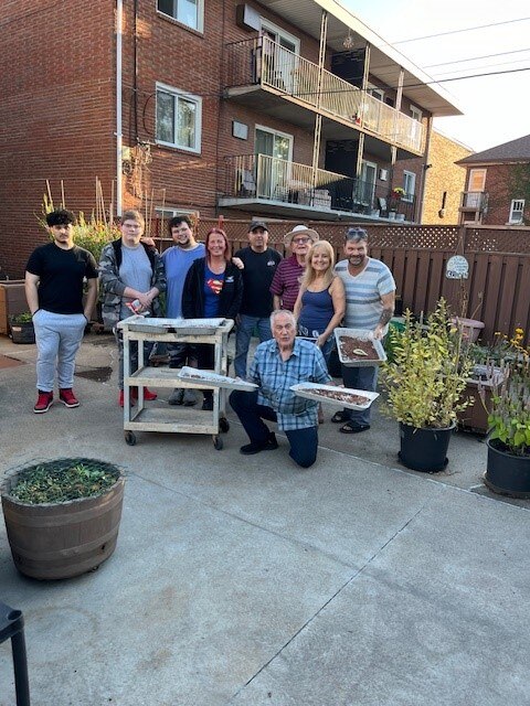Leo Silvestri, otherwise known as “The Milkweed Man,” shows volunteers how to prepare milkweed for planting.